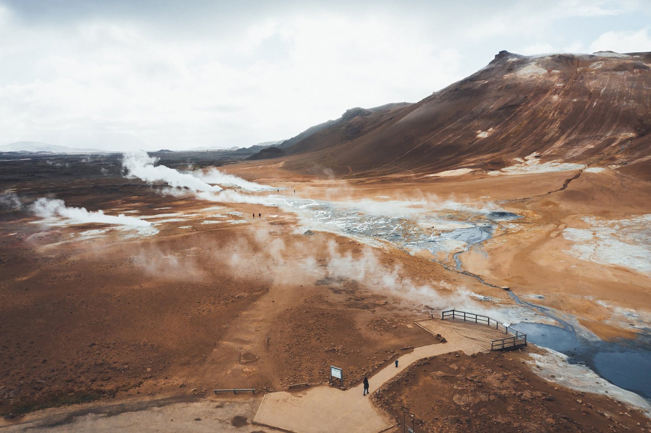 The barren lunar landscape Hverir, where bubbles and steam rise up from countless grey mud holes. (Visit North Iceland via dpa)