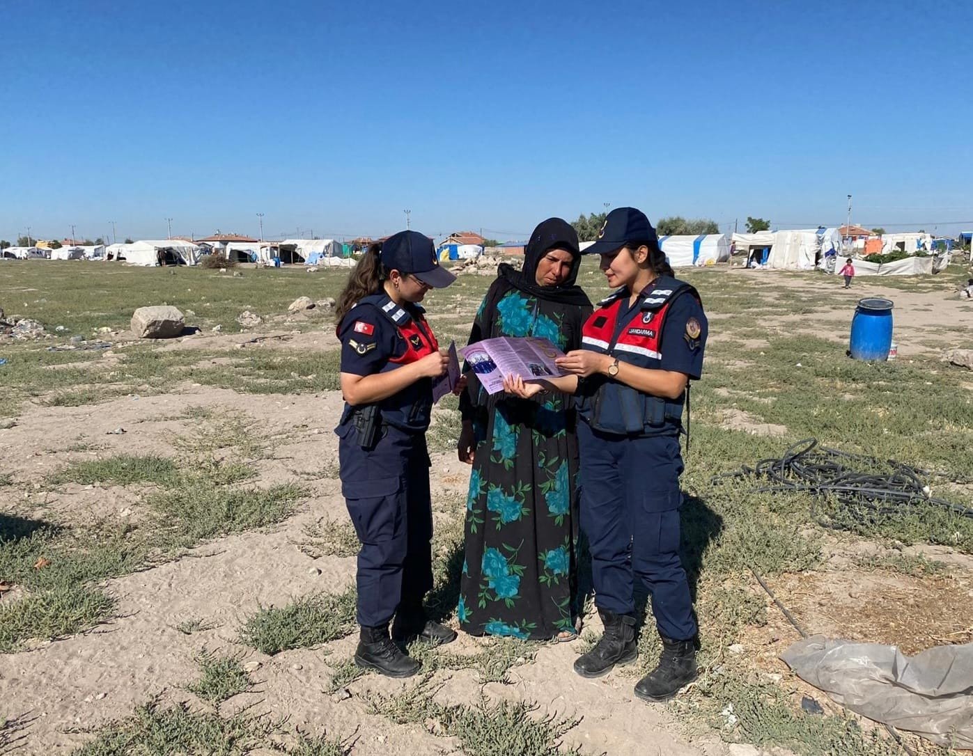 Gendarmerie officers inform a seasonal worker about assistance they can receive against violence, in Aksaray, central Turkey, Aug. 1, 2022. (İHA PHOTO) 
