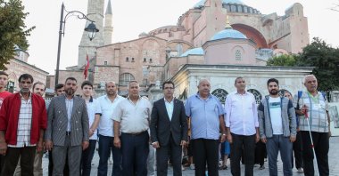 Representatives of the Romani community pose for a photo in front of Hagia Sophia Grand Mosque, in Istanbul, Turkey, Aug. 2, 2022. (AA PHOTO)
