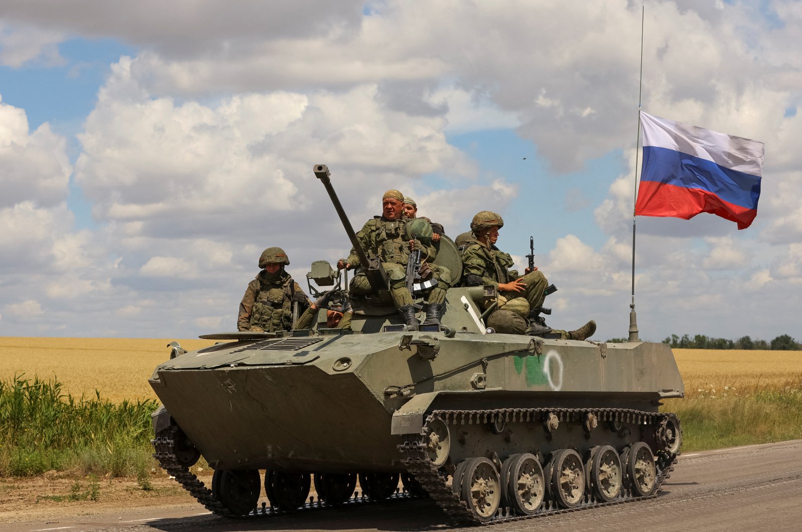 Service members of Russian troops ride on top an armored vehicle in the Russian-held part of the Zaporizhzhia region, Ukraine, July 23, 2022. (Reuters Photo)