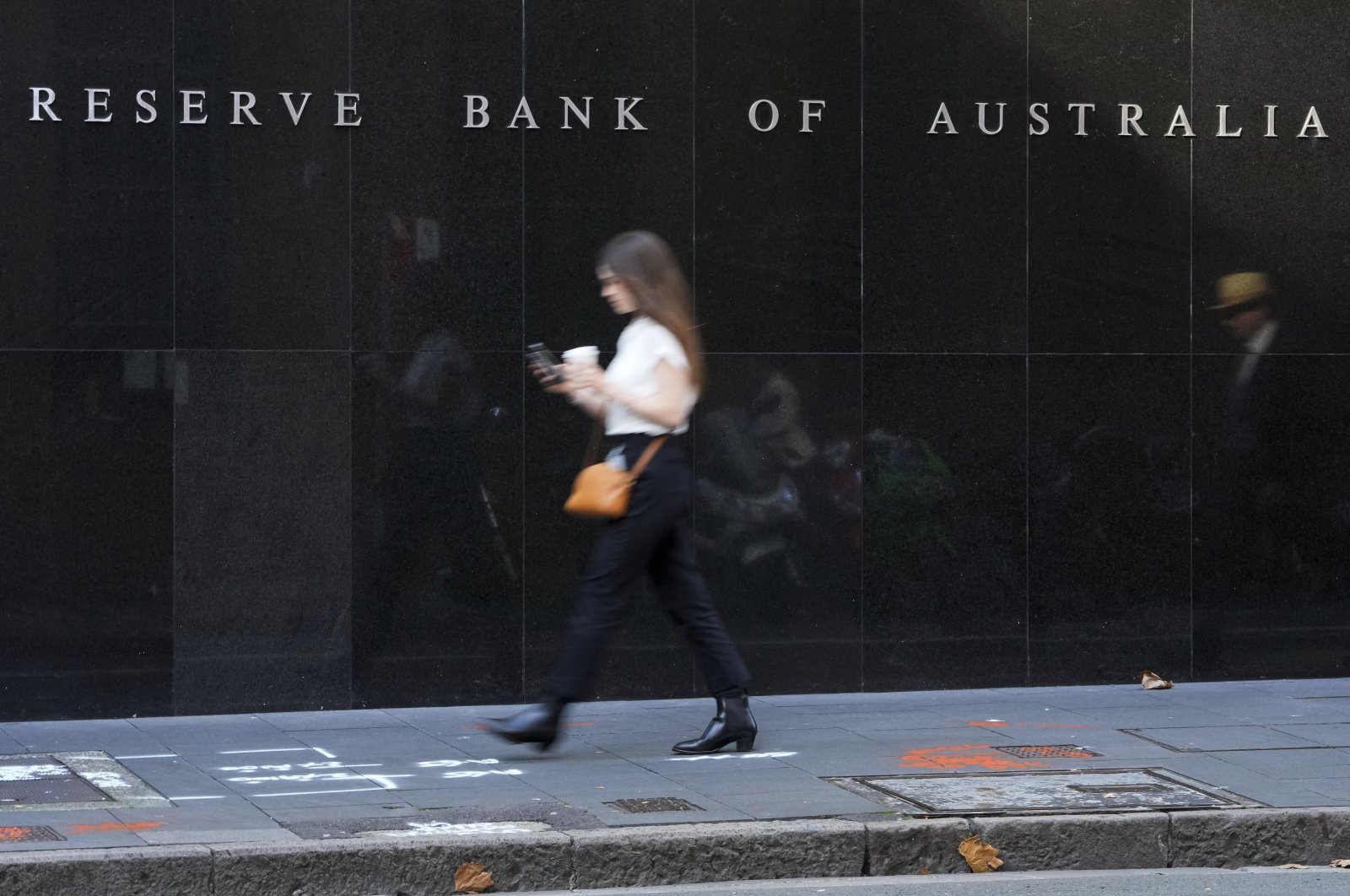 People walk past the outside of the Reserve Bank in Sydney, Australia, May 3, 2022. (AP Photo)