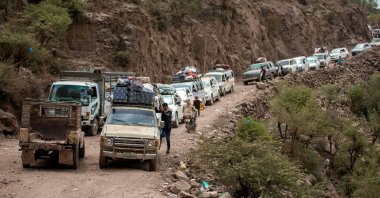Traffic is seen on a heavily damaged narrow road that serves as a lifeline between Taiz and the southern port of Aden in Yemen, July 8, 2022. (AFP Photo)