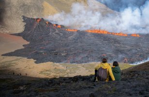 People look at the lava flowing at the scene of the newly erupted volcano at Grindavik, Iceland, Aug. 3, 2022. (AFP PHOTO)