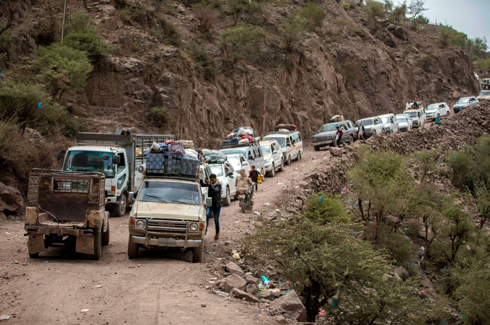 Traffic is seen on a heavily damaged narrow road that serves as a lifeline between Taiz and the southern port of Aden in Yemen, July 8, 2022. (AFP Photo)