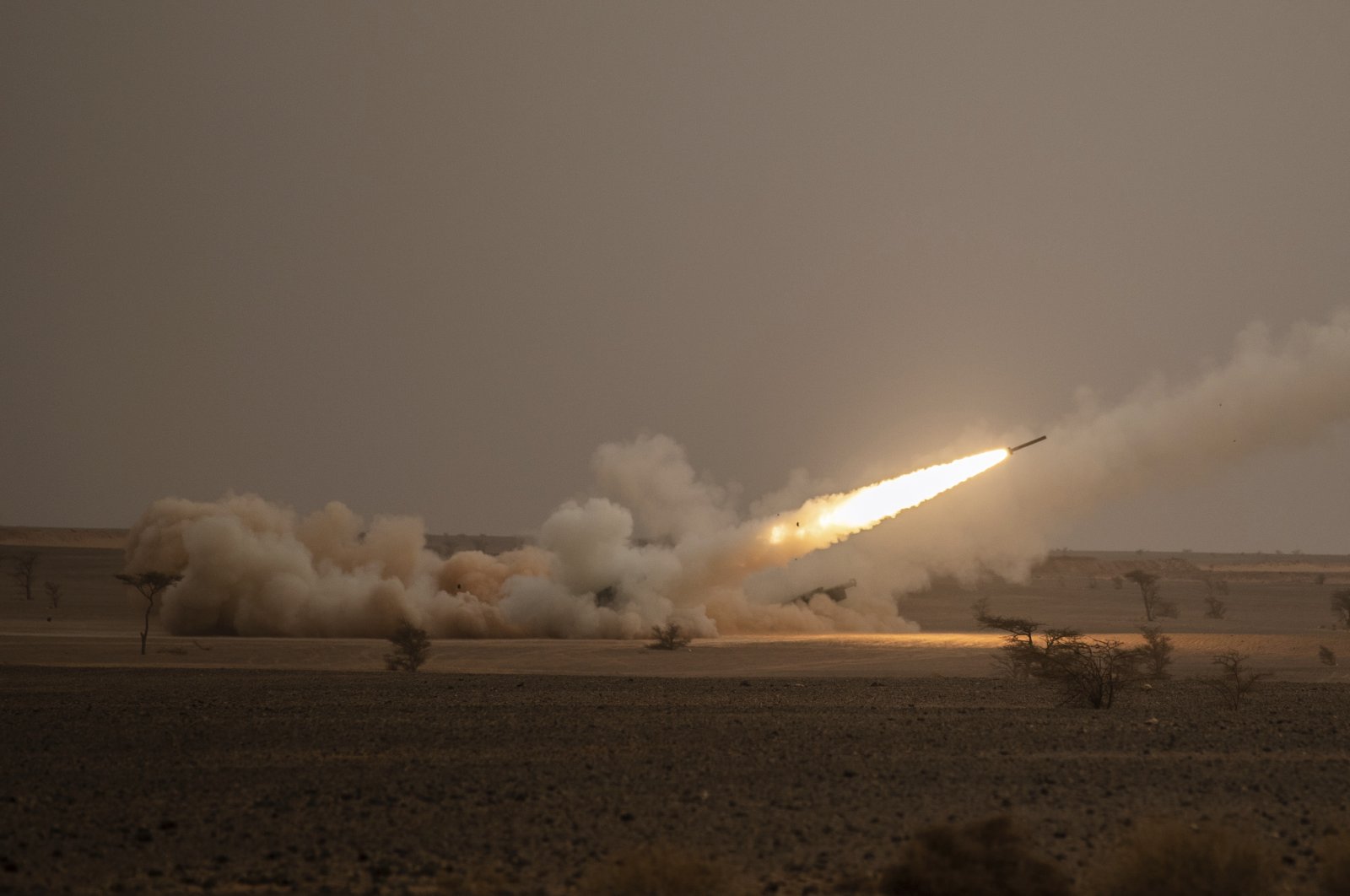 A launch truck fires the High Mobility Artillery Rocket System (HIMARS) at its intended target during the African Lion military exercise in the Grier Labouihi complex, southern Morocco, June 9, 2021. (AP Photo)
