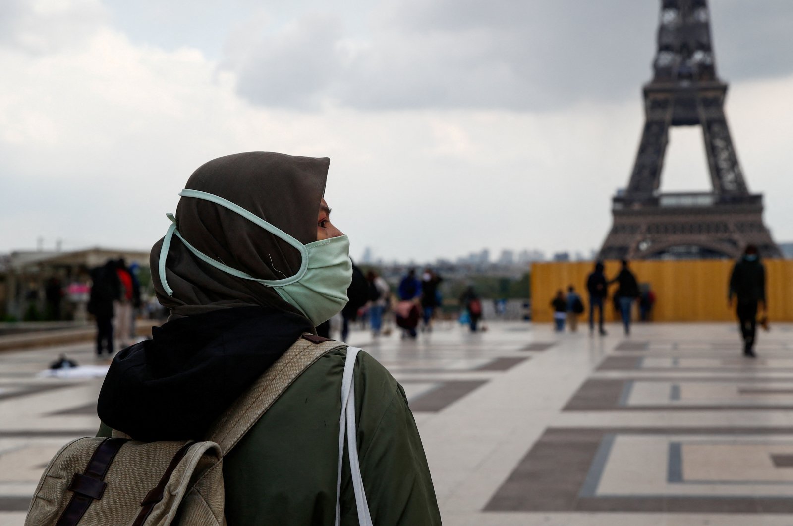 A woman, wearing a hijab and a protective face mask, walks at Trocadero square near the Eiffel Tower in Paris, France, May 2, 2021. (Reuters File Photo)