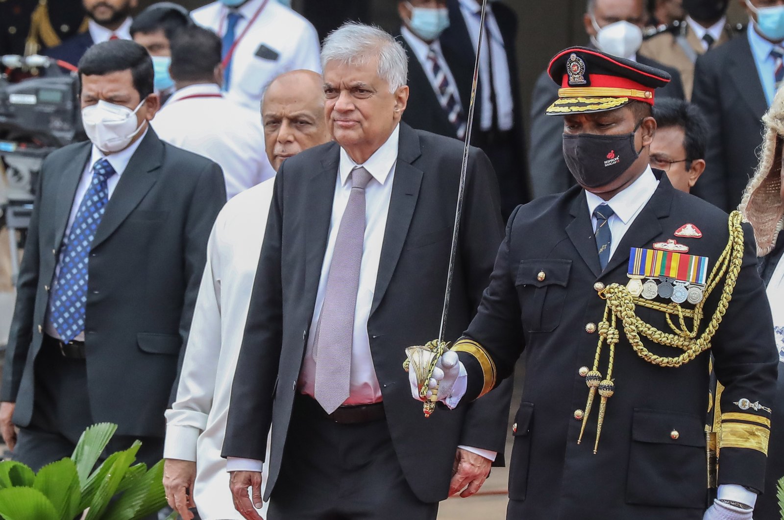 Sri Lankan President Ranil Wickremesinghe (2R), accompanied by Sri Lankan Prime Minister Dinesh Gunawardena (2L) leaves after addressing the ceremonial inauguration of the third session of ninth parliament in Colombo, Sri Lanka, Aug. 3, 2022. (EPA Photo)