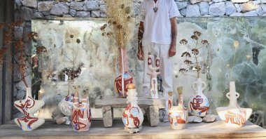 Carlito Dalceggio poses with his artwork for "Between Humankind and Nature." (Courtesy of ISTANBUL’74)