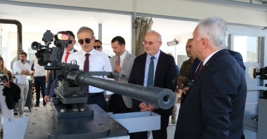 SSB Head Ismail Demir inspects domestic 12.7 mm machine gun at the Samsun Yurt Savunma facilities in Ankara, Turkey, Aug. 3, 2022. (IHA Photo)