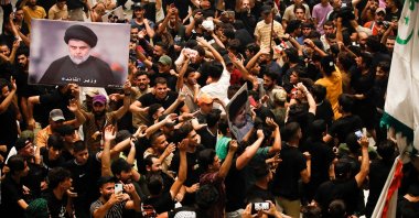 Supporters of Iraqi cleric Muqtada Sadr (image) wave flags as they occupy the Iraqi parliament for a fifth consecutive day, in protest at a nomination for prime minister by a rival Shiite faction, in the capital Baghdad's high-security Green Zone, Iraq, Aug. 3, 2022. (AFP Photo)