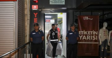 Police leave with evidence they collected after a raid at publishing house, in the capital Ankara, Turkey, Aug. 3, 2022. (AA PHOTO)