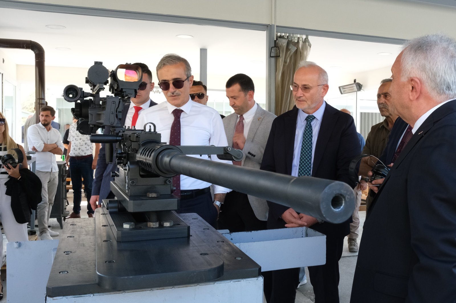 SSB Head Ismail Demir inspects domestic 12.7 mm machine gun at the Samsun Yurt Savunma facilities in Ankara, Turkey, Aug. 3, 2022. (IHA Photo)