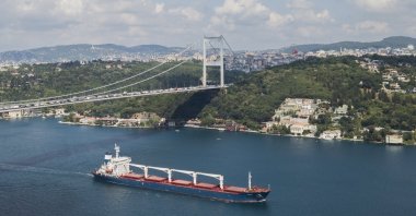 An aerial picture taken by drone shows Sierra Leone-flagged cargo ship Razoni sailing under Fatih Sultan Mehmet Bridge through the Bosporus after an inspection in Istanbul, Turkey, Aug. 3, 2022.(EPA Photo)