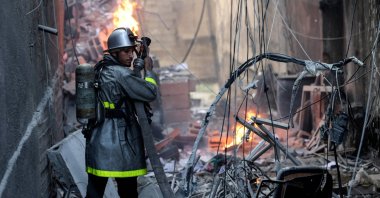 A Palestinian firefighter tackles the blaze amid the destruction following an Israeli air strike on Gaza City, Palestine, Aug. 5, 2022. (AFP Photo)