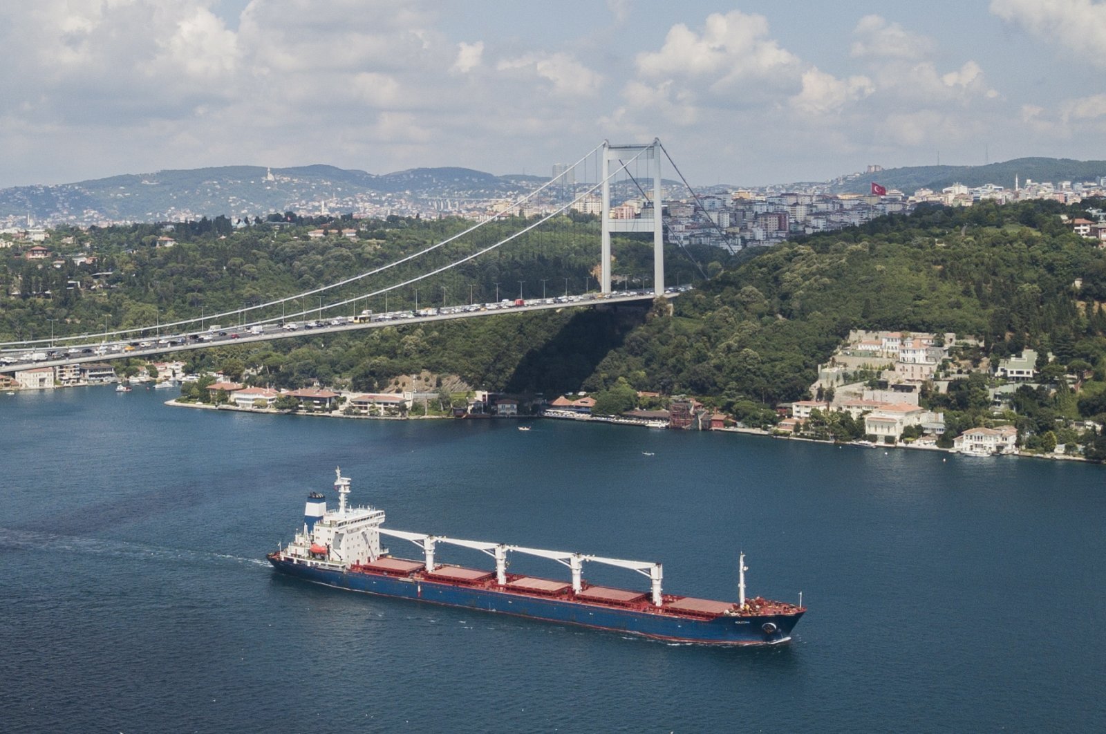 An aerial picture taken by drone shows Sierra Leone-flagged cargo ship Razoni sailing under Fatih Sultan Mehmet Bridge through the Bosporus after an inspection in Istanbul, Turkey, Aug. 3, 2022.(EPA Photo)