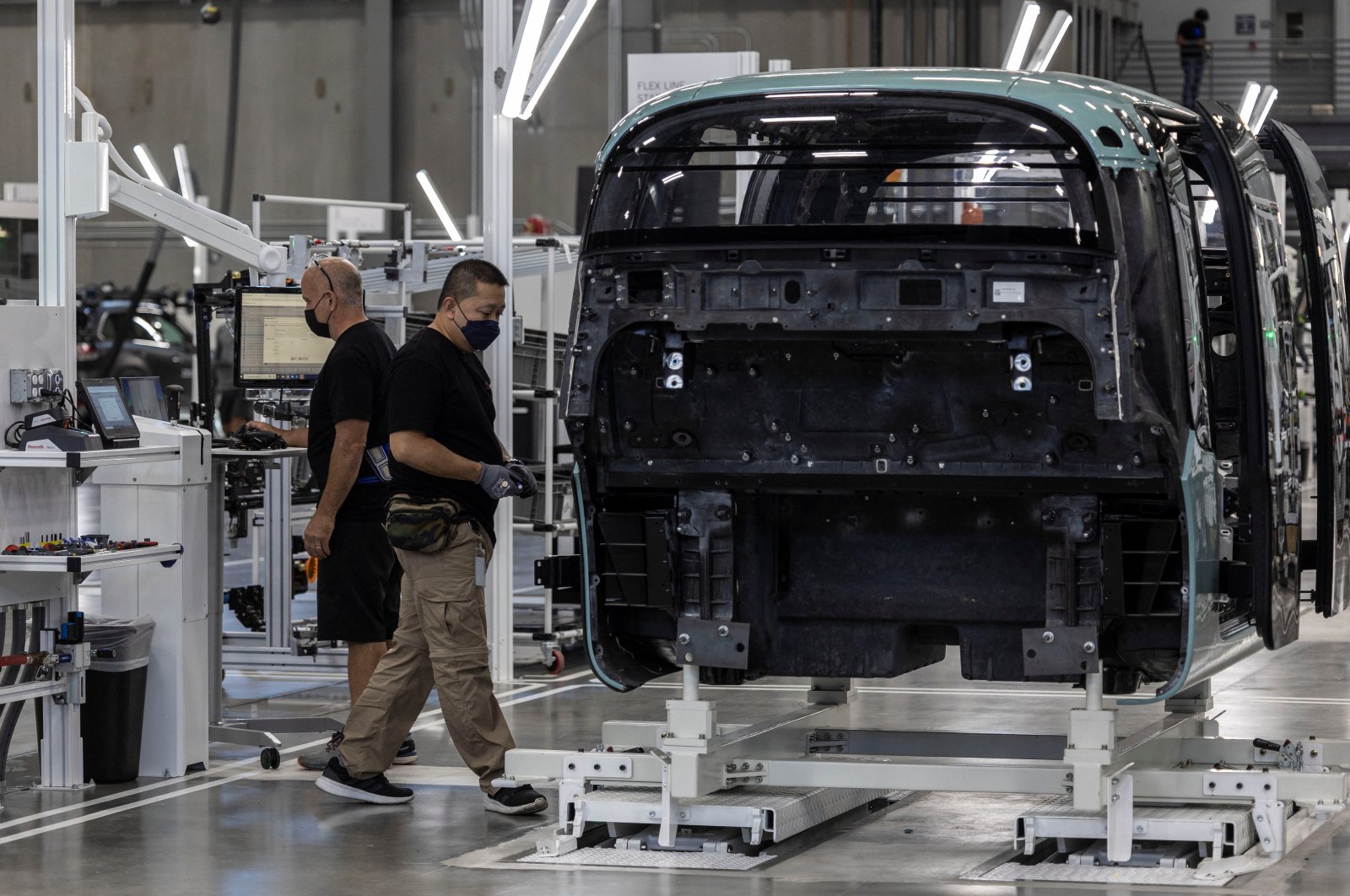 Employees work at the assembly line of Zoox, a self-driving vehicle owned by Amazon, at the company&#039;s factory in Fremont, California, U.S. July 19, 2022.  (Reuters Photo)