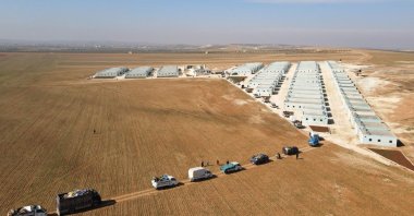 Displaced Syrians arriving at a new housing site in the opposition-held area of Bizaah, east of al-Bab built with the support of Turkey's emergency agency AFAD, Syria, Feb. 9, 2022. (AFP Photo)