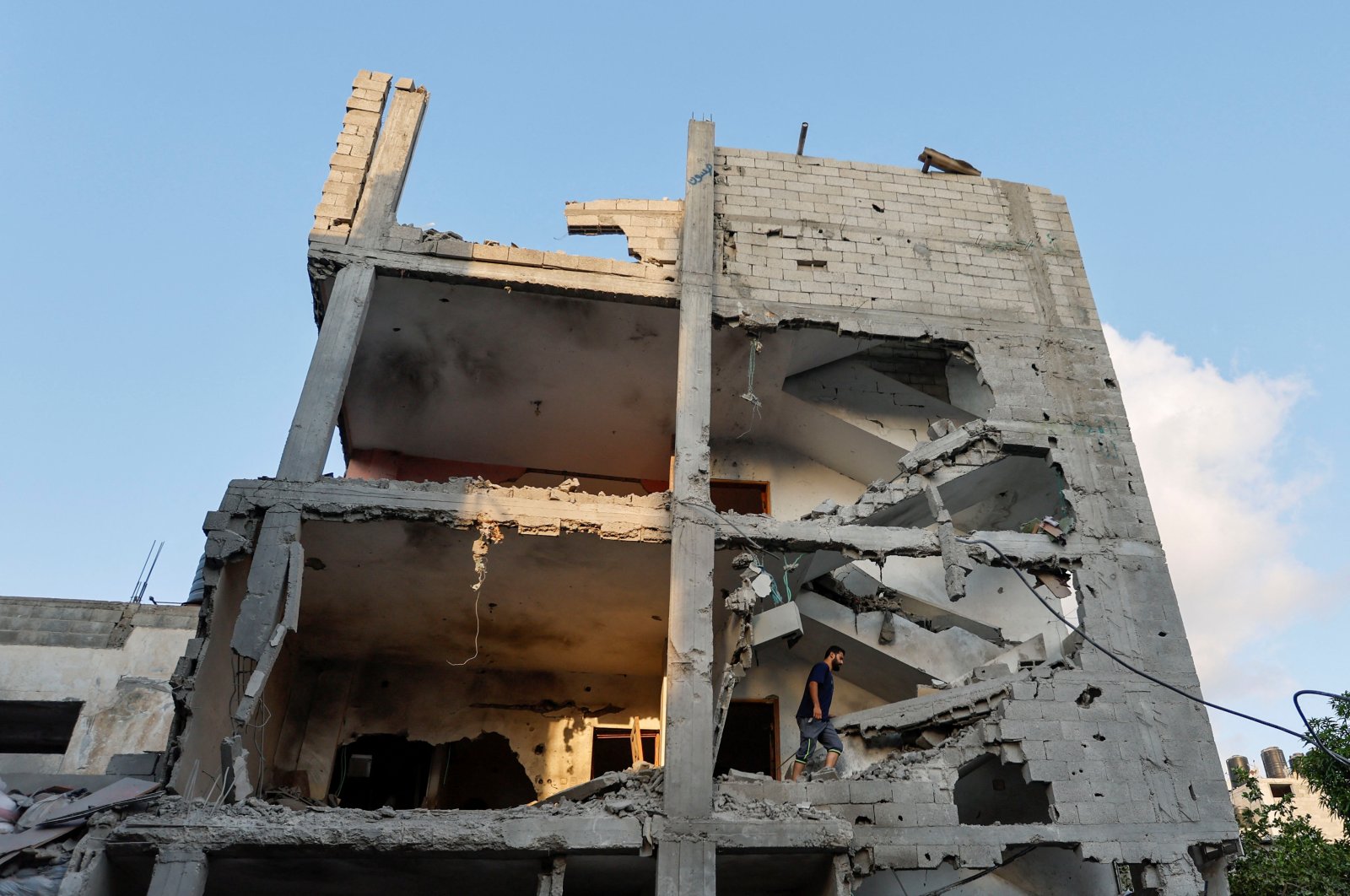 A Palestinian man walks through the ruins of a house at the scene where senior commander of Islamic Jihad group Khaled Mansour was killed in Israeli strikes, in Rafah in the southern Gaza Strip, Palestine, Aug. 7, 2022. (Reuters Photo)