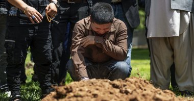 Altaf Hussain cries over the grave of his brother Aftab Hussein at Fairview Memorial Park in Albuquerque, N.M., on Friday, Aug. 5, 2022. (AP Photo)