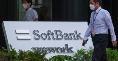 The logo of Japan&#039;s SoftBank Group is displayed at an entrance of their headquarters building in Tokyo, Aug. 8, 2022. (Photo by Kazuhiro NOGI / AFP)