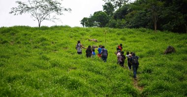 Guarani Indigenous people arrive for a visit to the land where they will move to, the Yara Mirim Indigenous land, in the municipality of Marica, Rio de Janeiro State, Brazil, July 29, 2022. (AFP Photo)