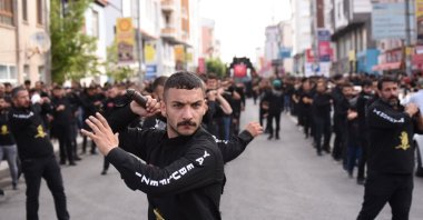 People beat their backs and chests in a parade on the occasion, in Kars, eastern Turkey, Aug. 8, 2022. (AA PHOTO) 