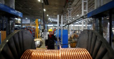 A worker checks copper cables being produced at a factory in the central Anatolian city of Kayseri, Turkey, Feb. 12, 2015. (Reuters Photo)
