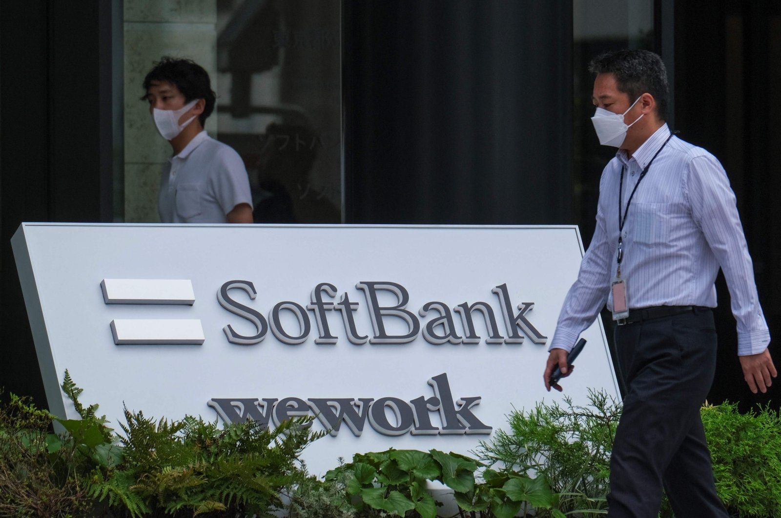 The logo of Japan&#039;s SoftBank Group is displayed at an entrance of their headquarters building in Tokyo, Aug. 8, 2022. (Photo by Kazuhiro NOGI / AFP)