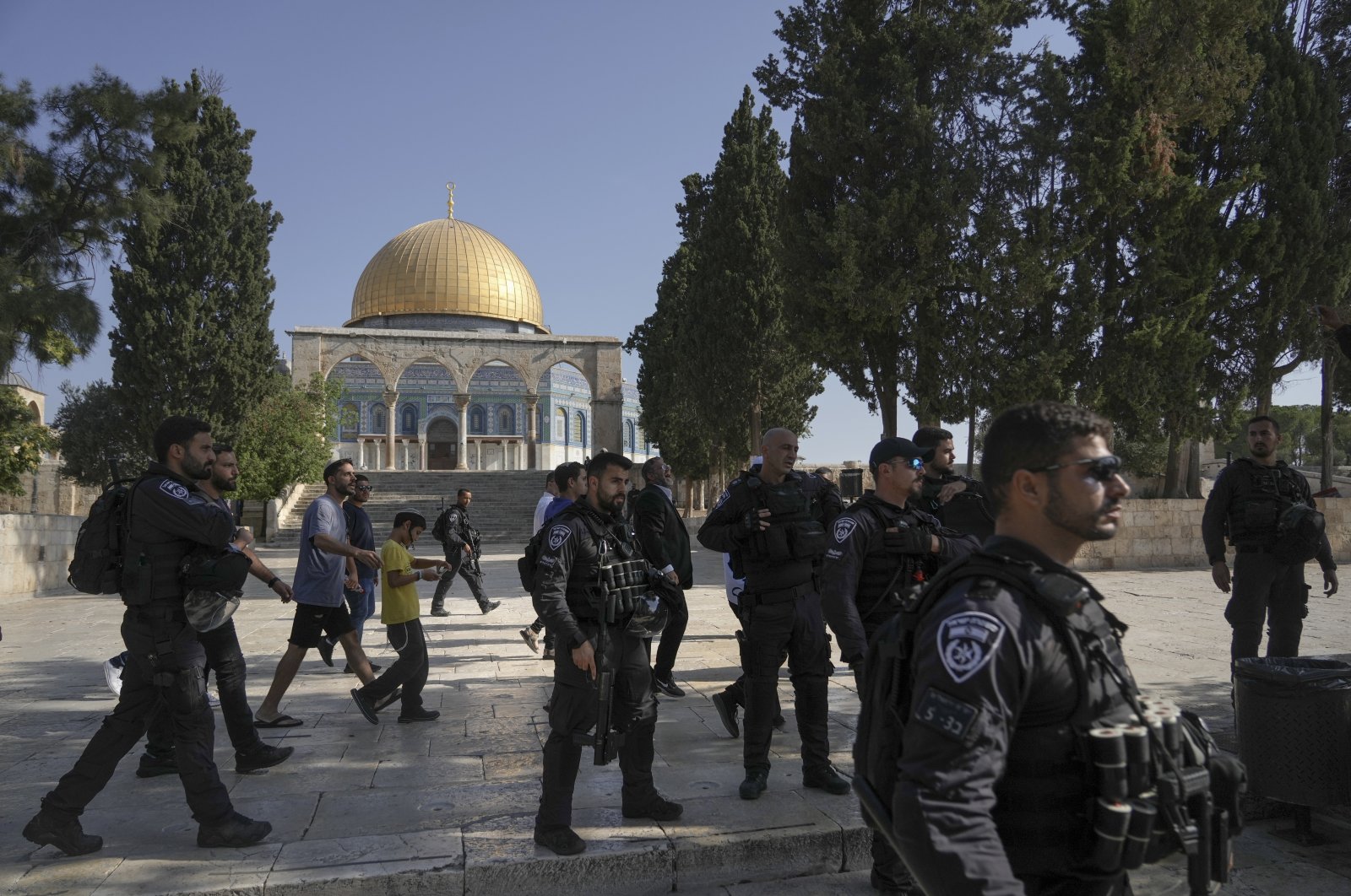 Israeli police officers escort a group of Jewish men visiting the Temple Mount, known to Muslims as the Noble Sanctuary, on the Al-Aqsa Mosque compound in the Old City of Jerusalem, Aug. 7, 2022. (AP Photo/Mahmoud Illean)