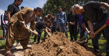 People spread dirt over Aftab Hussein's grave at Fairview Memorial Park in Albuquerque, New Mexico, U.S., Aug. 5, 2022. (The Albuquerque Journal via AP)
