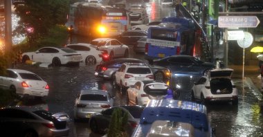 Abandoned vehicles fill the road in flooded area during heavy rain in Seoul, South Korea, Aug. 8, 2022. (Yonhap via Reuters)