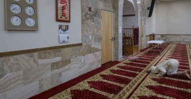 A young man bows during the Dhuhr afternoon prayer at the Islamic Center of New Mexico, U.S., Aug. 7, 2022. (Adolphe Pierre-Louis/The Albuquerque Journal via AP)