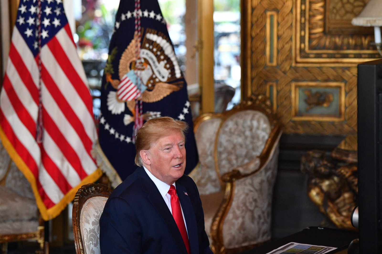 Former U.S. President Donald Trump makes a video call to troops stationed worldwide at the Mar-a-Lago estate in Palm Beach Florida, U.S., Dec. 24, 2019. (AFP Photo)