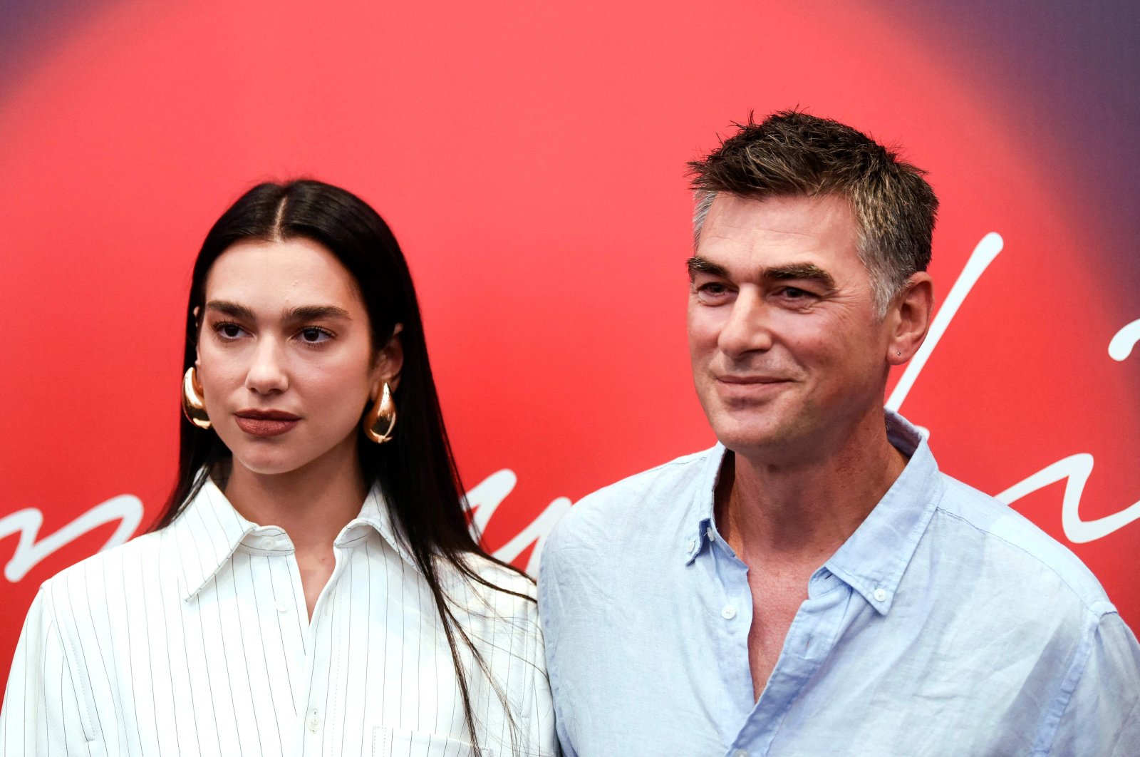 English singer and songwriter Dua Lipa (L) and her father Dukagjin Lipa pose after a press conference ahead of her performance at the Sunny Hill Festival in Pristina, Kosovo, Aug. 4, 2022. (AFP Photo)