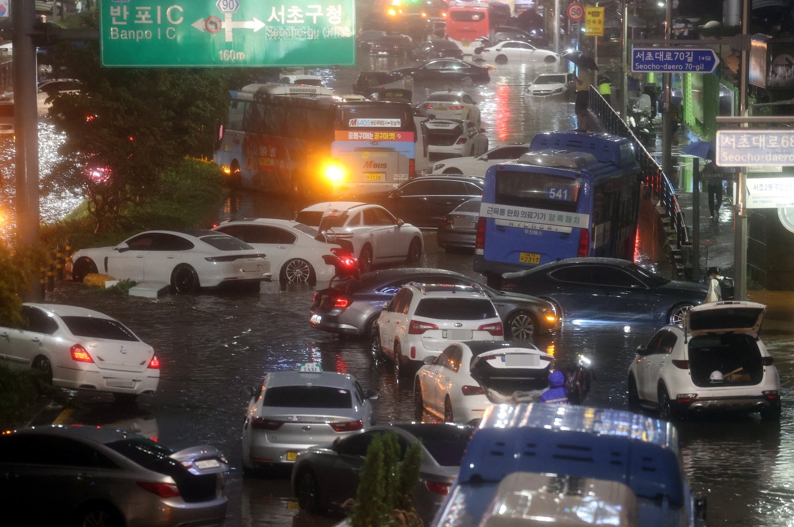 Abandoned vehicles fill the road in flooded area during heavy rain in Seoul, South Korea, Aug. 8, 2022. (Yonhap via Reuters)