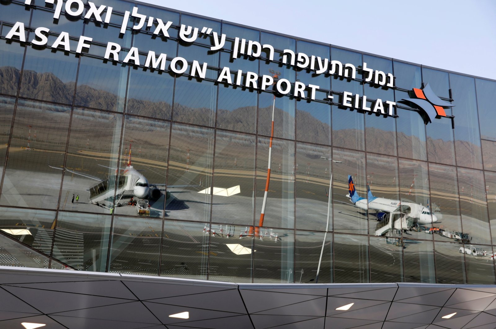 Planes are reflected in the facade of the Ramon International Airport after an inauguration ceremony for the new airport, just outside the southern Red Sea resort city of Eilat, Israel Jan. 21, 2019. (Reuters File Photo)