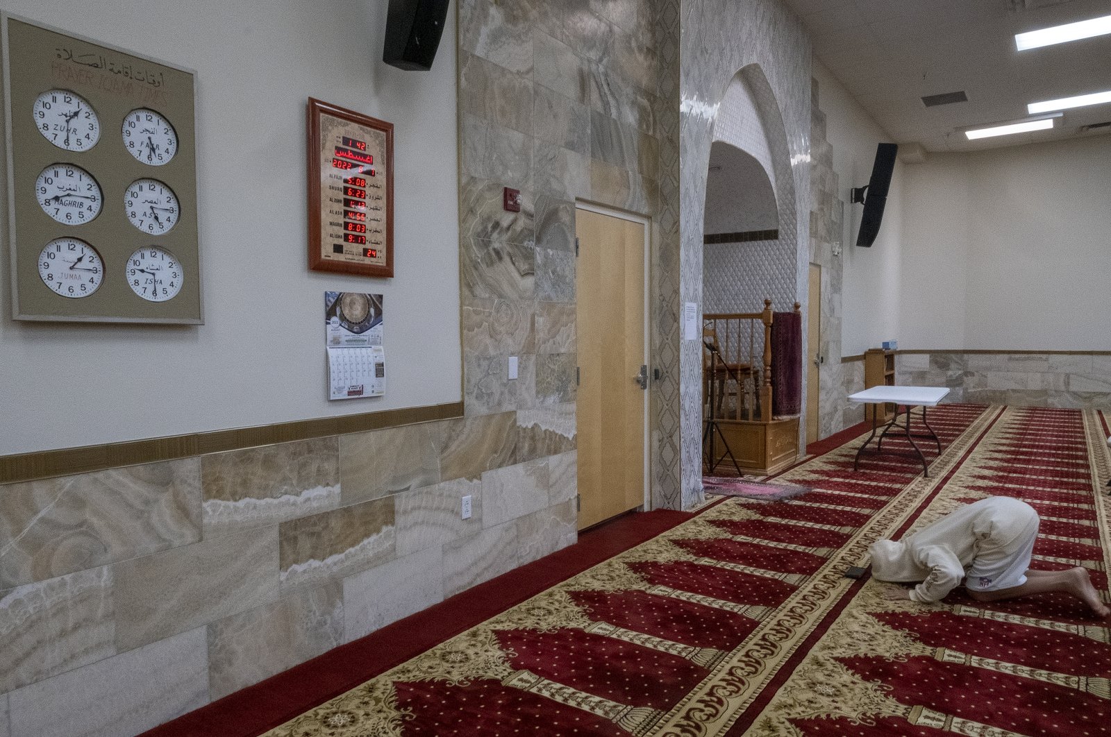 A young man bows during the Dhuhr afternoon prayer at the Islamic Center of New Mexico, U.S., Aug. 7, 2022. (Adolphe Pierre-Louis/The Albuquerque Journal via AP)