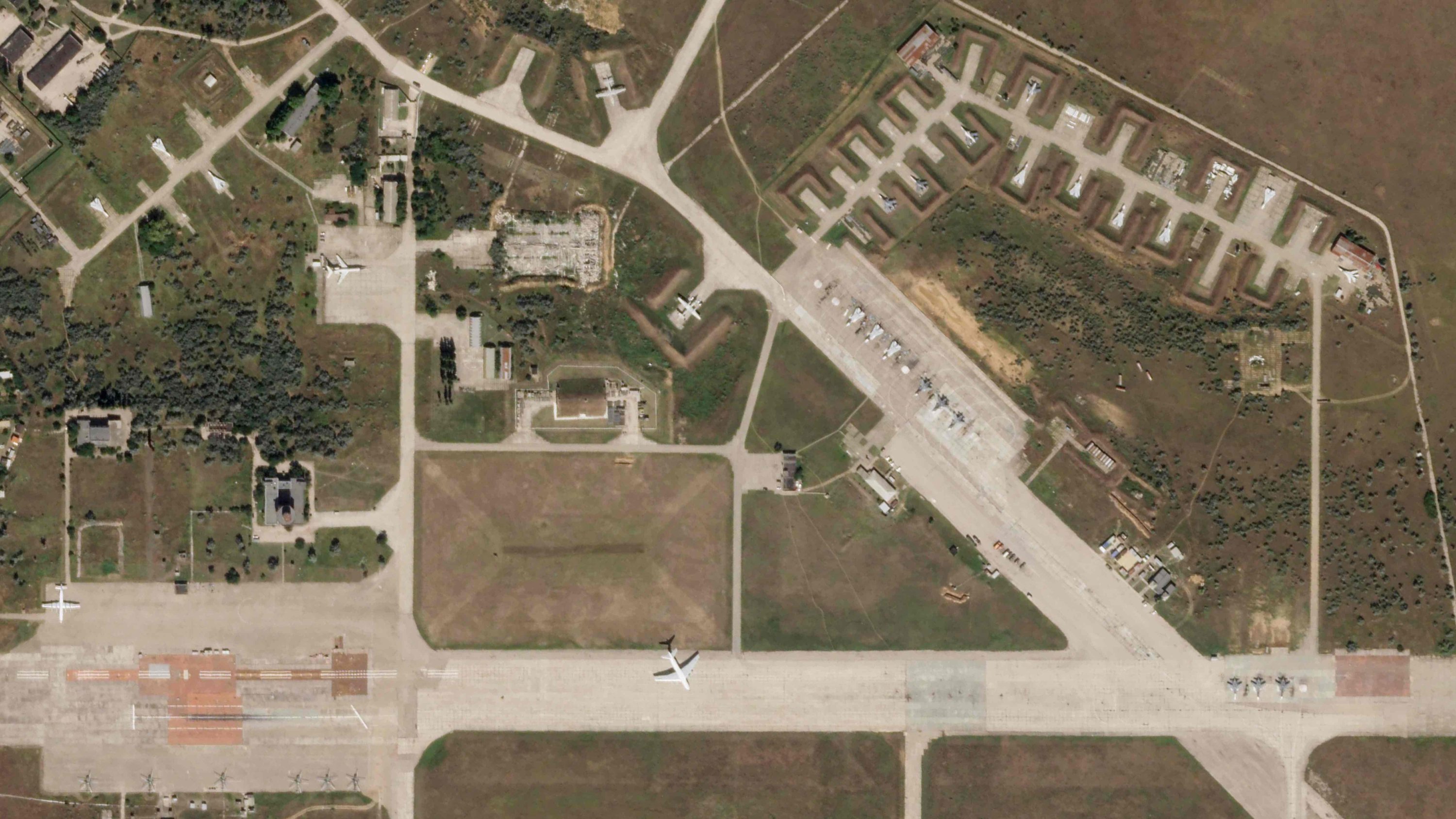 A satellite image by Planet Labs PBC shows aircraft at Saky Air Base before an explosion, Aug. 9, 2022, in the Crimean Peninsula. (Planet Labs PBC via AP)
