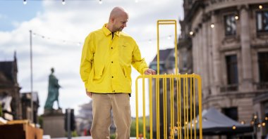 Artist Kostya Benkovich, who fled Russia because of his anti-war stance, presents his sculpture "The Suitcase" during a photo call at the Assembly Gardens, Edinburgh. (DPA Photo)