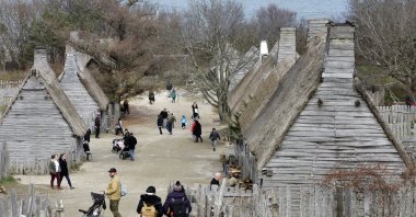 Visitors walk through the 17th-Century English Village exhibit at the Plimoth Patuxet Museums in Plymouth, Massachussets, Nov. 18, 2018. (AP Photo)