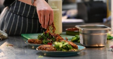 A member of staff prepares some food at The Canteen restaurant in Bristol, U.K.,  Aug. 3, 2022. (AFP Photo)