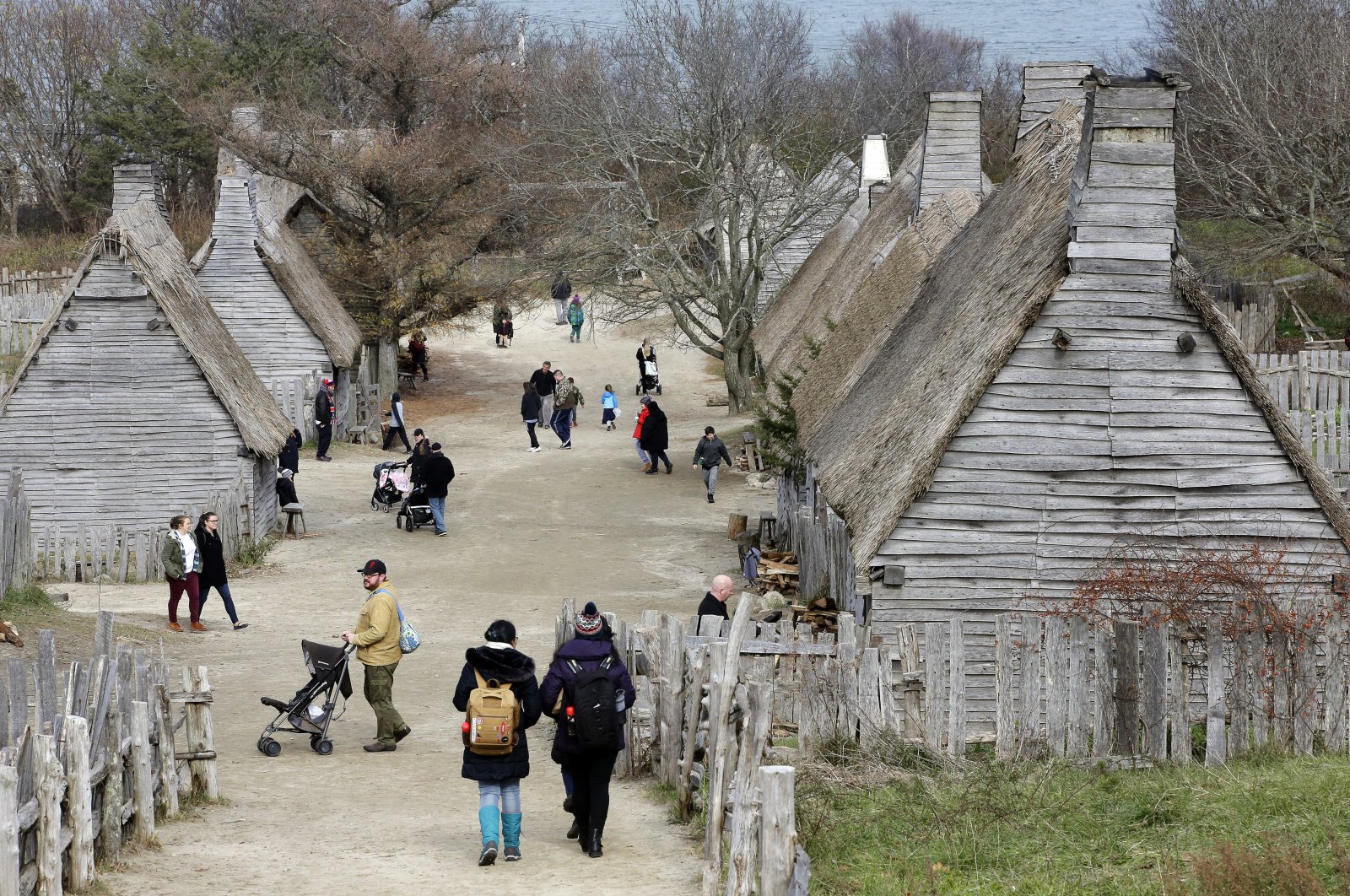 Visitors walk through the 17th-Century English Village exhibit at the Plimoth Patuxet Museums in Plymouth, Massachussets, Nov. 18, 2018. (AP Photo)