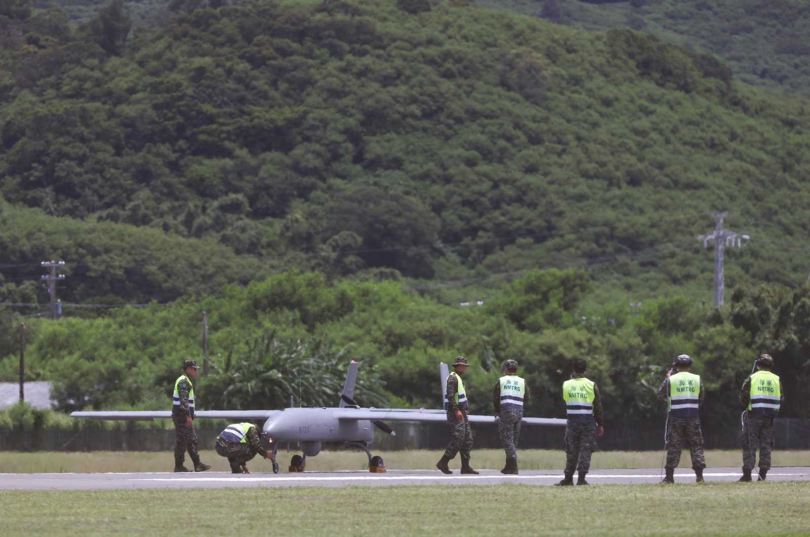 Military personnel stand near an Albatross unmanned aerial vehicle (UAV), during a military exercise at the Hengchun airport in Pingtung county, southern Taiwan, Aug. 9, 2022. (Reuters Photo)