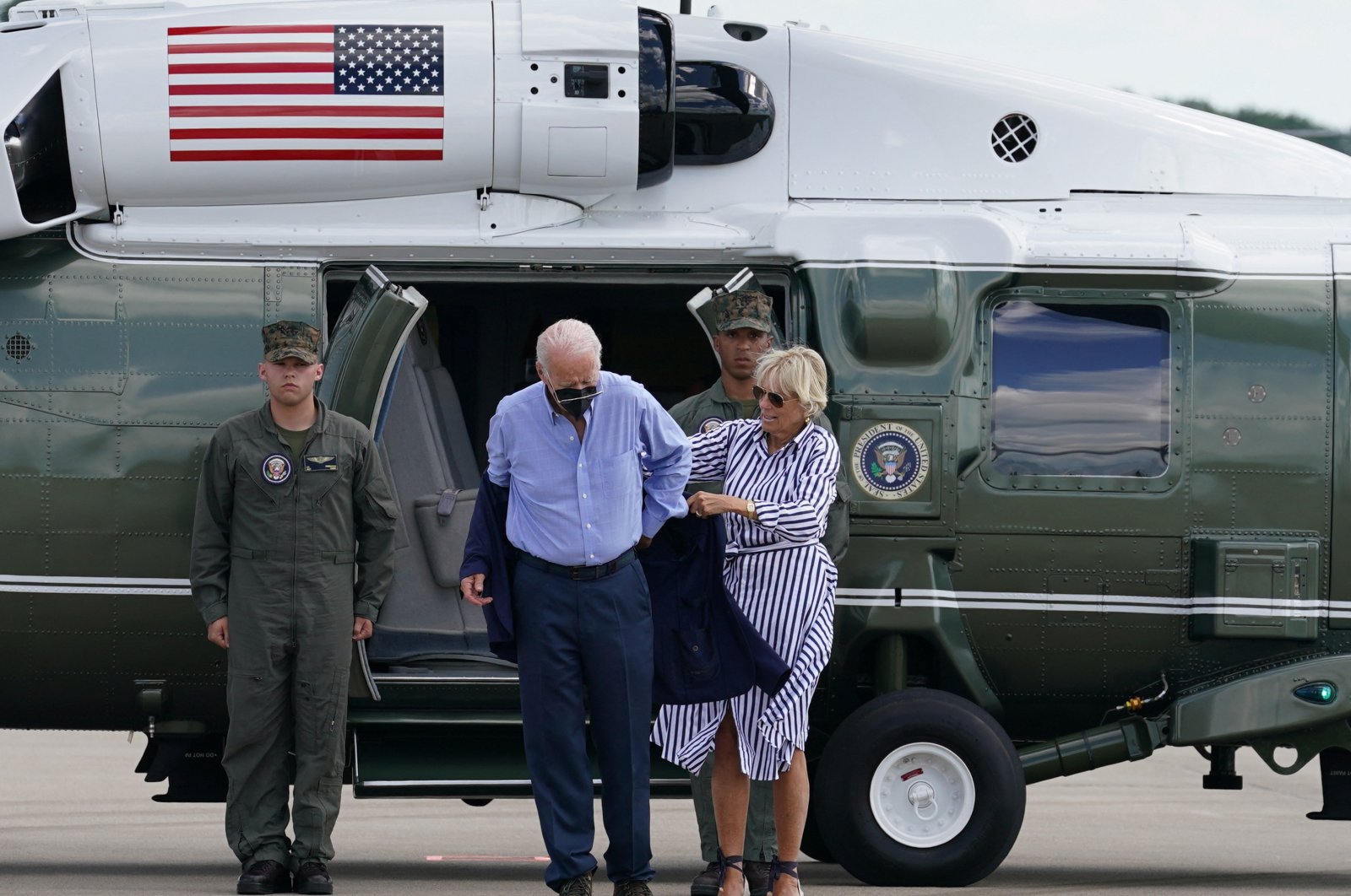 U.S. President Joe Biden gets a bit of help putting on his jacket from first lady Jill Biden as they step from Marine One to board Air Force One as they depart Lexington, Kentucky, U.S., Aug. 8, 2022. (Reuters Photo)