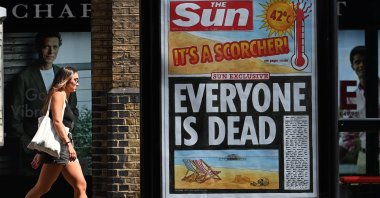 A pedestrian walks past a newspaper headline highlighting the extreme heat in London, U.K., July 20, 2022. (EPA Photo)