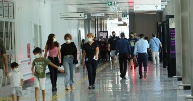 People wearing protective masks walk inside a hospital in Mersin, southern Türkiye, July 25, 2022. (İHA PHOTO)