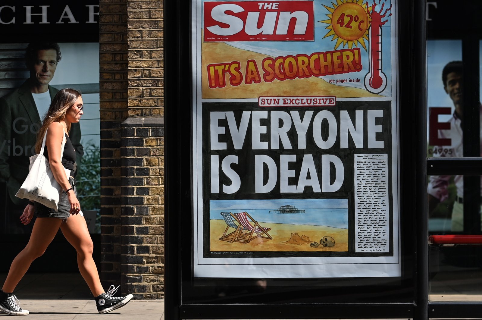 A pedestrian walks past a newspaper headline highlighting the extreme heat in London, U.K., July 20, 2022. (EPA Photo)