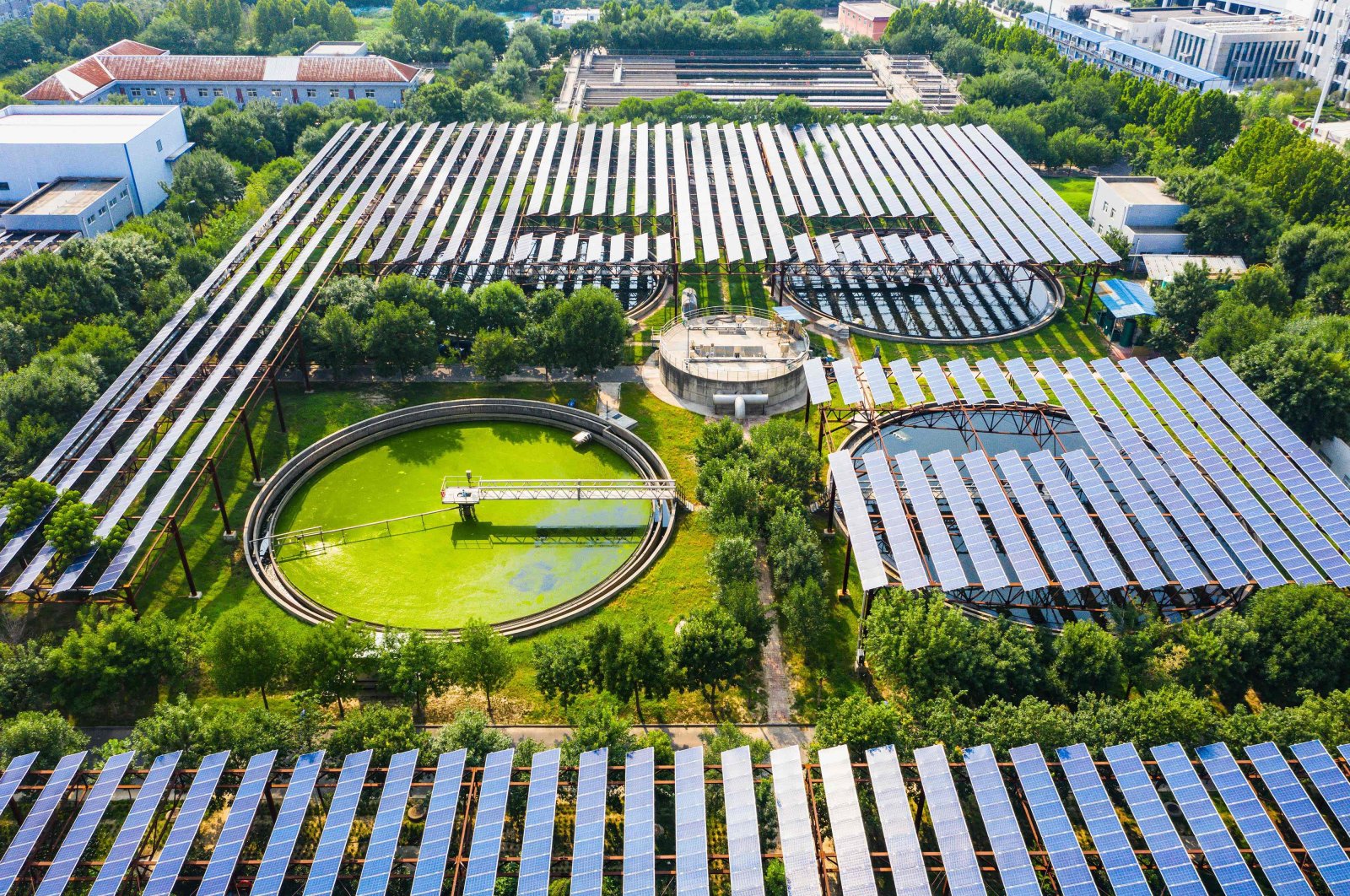 This aerial photo shows solar panels built over a sewage treatment plant in Zhengzhou, Henan province, China, Aug. 4, 2022. (AFP Photo)