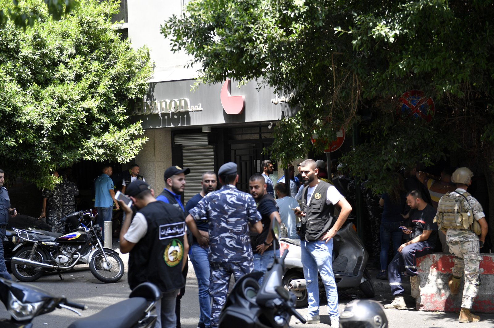 Lebanese security forces stand at the area of a bank in Hamra area where an armed man took clients and employees hostages, in Beirut, Lebanon, 11 August 2022. (EPA)