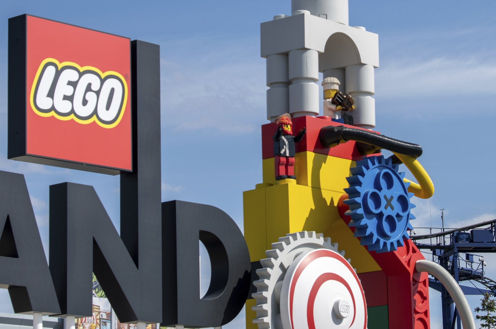 A roller coaster can be seen next to the Lego logo at the entrance to the Legoland amusement park in Guenzburg, southern Germany, Aug. 11, 2022. (dpa Photo via AP)